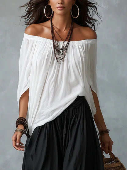Top Blanco con los Hombros Descubiertos y Pantalones Acampanados Estilo Farol.